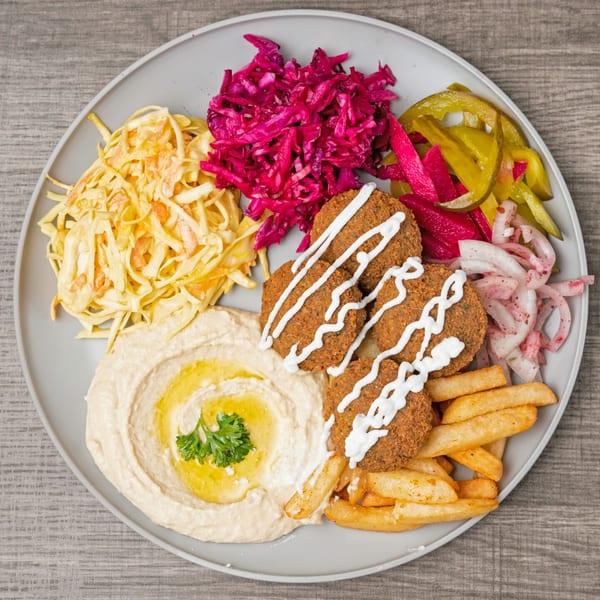 SK Shawarma's falafel plate with hummus, fries, pickled vegetables, and shredded cabbage.
